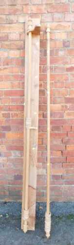 Two pine curtain poles, with rings, one on a pine mount, approx 202cm long.