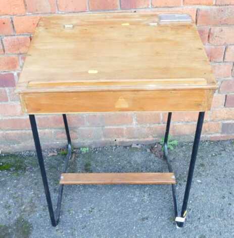 A ply school desk, on U shaped metal legs, with wooden stretcher, 67cm high.