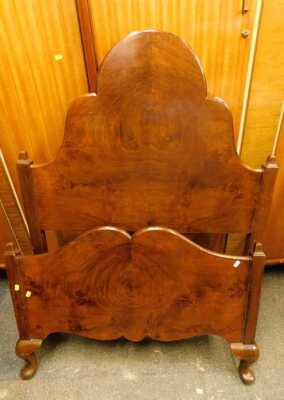 A 1920s walnut single bed head and footboard.