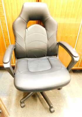 A black faux leather upholstered swivel office chair.