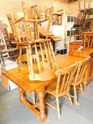 A pine dining table, the rectangular top raised on turned legs, with H stretcher, 77cm high, the top 159cm x 82.5cm, together with six dining chairs. (7)