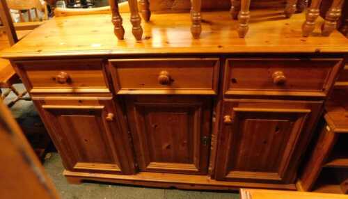 A pine sideboard, with shaped raised back, the base with three drawers above three cupboards, on bracket feet, 96cm high, 132cm wide, 47cm deep, together with a television stand, 60cm high, 94cm wide, 59cm deep.