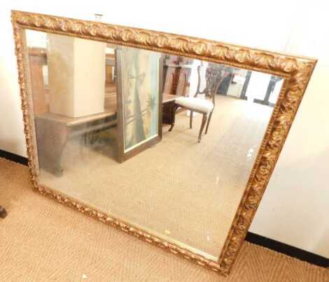 A gilt framed wall mirror, of rectangular form, the border with scrolling leaf decoration,106cm x 128cm.