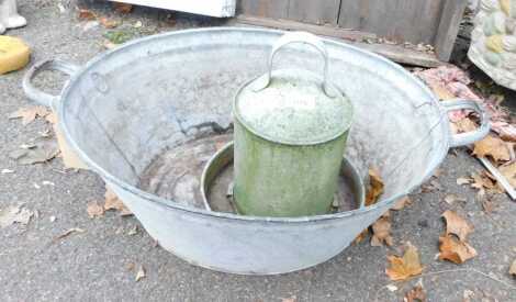 A galvanised metal twin handled wash tub, of oval form, 58cm wide, together with two further galvanised metal wares.