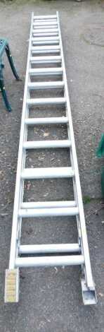 An aluminium extending step ladder, approx 680cm long extended.