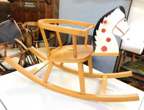 A beech rocking horse, with a painted head, 57cm high.