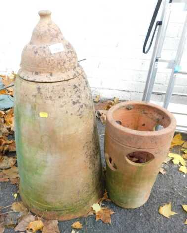 A terracotta rhubarb forcer, with lid, 72cm high, together with a terracotta strawberry type pot, 38cm high. (2)