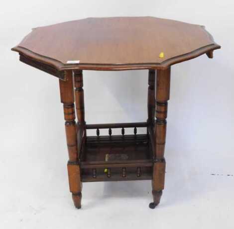 An Edwardian mahogany window table, the octagonal top raised on turned columns, with under tier, on castors, 72cm high. (AF)