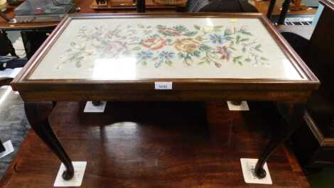 A 20thC beech occasional table, the top inset with a floral tapestry panel, on cabriole legs with pad feet, 45cm high, the top 71cm x 40cm.