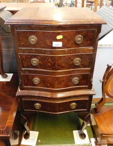 A 20thC walnut and mahogany serpentine miniature chest, of four drawers, on shell capped cabriole legs with pad feet, 78cm high, 41cm wide, 30cm deep.