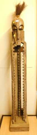 A carved hardwood CD rack, modelled as a tribal style figure, 167cm high.