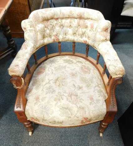 A Victorian oak framed tub chair, with overstuffed upholstered seat and back, on turned legs with castors.