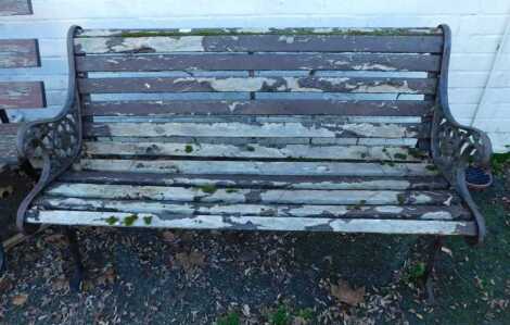 A garden bench, with wooden slatted seat and back, on cast iron end supports, 125cm wide.