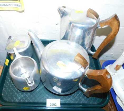 An aluminium Piquot ware service, comprising teapot, coffee pot, milk jug and sugar bowl.