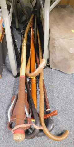 A hockey stick, various shooting sticks, walking sticks, etc. (1 bay)