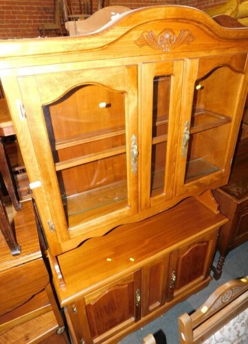 A 20thC beech dresser, the top with two glazed doors flanking a central glass panel, above a recess, the base with two panelled cupboard doors, on a plinth, 192cm high, 120cm wide, 38cm deep.