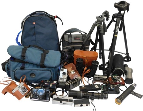 A group of camera related equipment, to include a Jessop camera bag, Prima Photo tripod, a Vanguard VEO2 Pro tripod, a Manfrotto rucksack, Telstar 12x50 field binoculars in case, further camera bags.