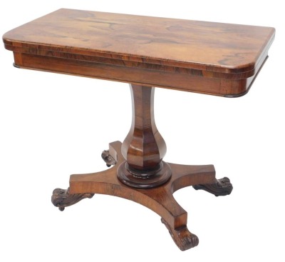 A William IV rosewood card table, the top with rounded corners, on a baluster column, concave platform and scroll legs, 92cm wide.