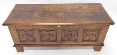 An 18thC Continental oak coffer, with lift top over four carved panels to the front, raised on stiles, 59cm high, 142cm wide, 53cm deep. - 2