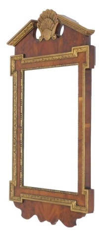 A George II style parcel gilt walnut wall mirror, with broken arch pediment and shell cornice and fret work frame, 76cm high.