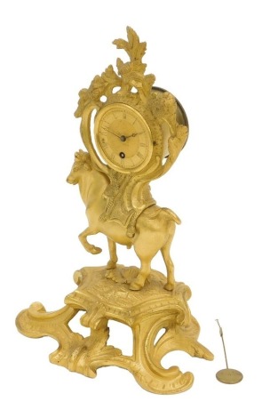 A 19thC French gilt brass table clock, of rococo scrolling form with a bull mounted by a cartel form, dial with Roman numerals, 26cm high.