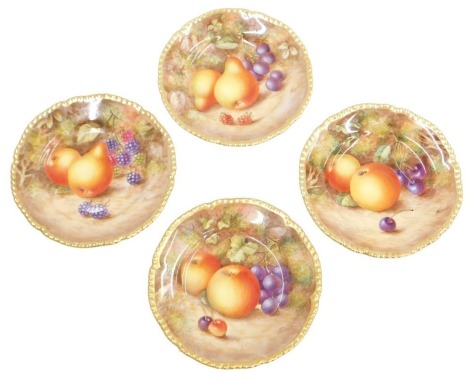 A set of four Royal Worcester porcelain plates, depicting fruit, signed Freeman, 15cm diameter.