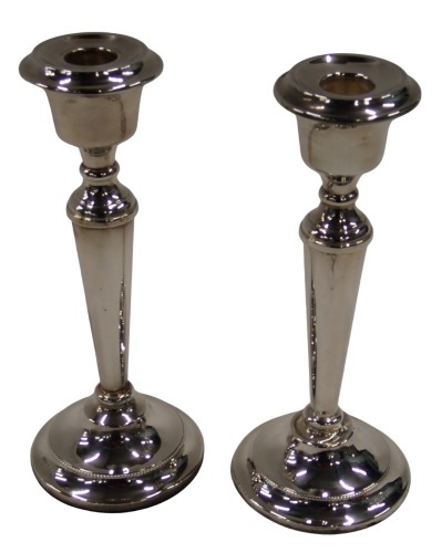 A pair of Elizabeth II silver candlesticks, on stepped and rope twist foot, Birmingham 1968, on weighted bases, 21cm high.