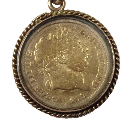 A 9ct gold coin pendant and chain, the graduated curb link neck chain, yellow metal stamped 9ct, 40cm long, with an enamel decorated George III with plated and enamelled replica sovereign, in twist frame mount, yellow metal stamped 9ct, 65g all in.