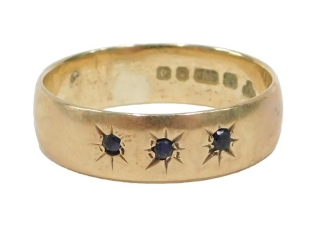 A 9ct gold dress ring, set with three star set sapphires, ring size I½, 2.1g all in.