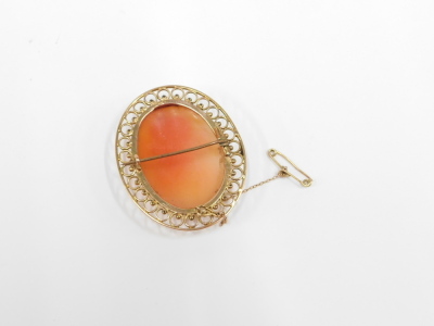 A shell cameo brooch, with maiden looking dexter, with half moon headdress, in a yellow metal pierced frame border, on single pin back with safety chain, unmarked, 4cm x 4.5cm, 11.8g all in. - 2