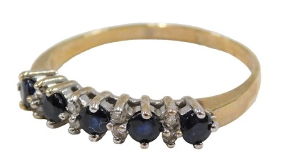 A 9ct gold sapphire and diamond half hoop dress ring, set with five sapphires, each claw set, and eight round brilliant cut diamonds, ring size T½, 2.6g all in.