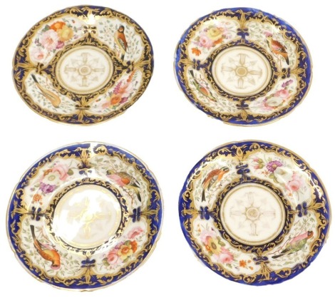 A set of four early 19thC porcelain dessert dishes, with blue and gilt decoration and reserves of birds and flowers.