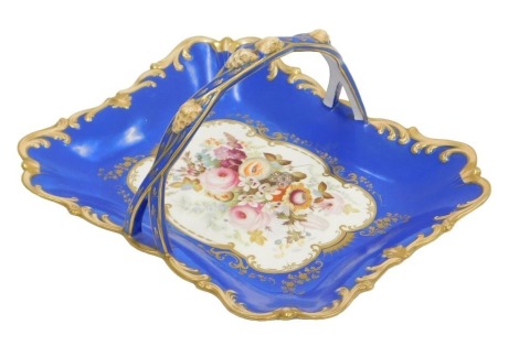 A 19thC porcelain cake basket, with blue and gilt rococo border and a central field of roses and other flowers, 28cm wide.