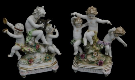 A pair of Continental porcelain figure groups, and a seated figure with a dog.