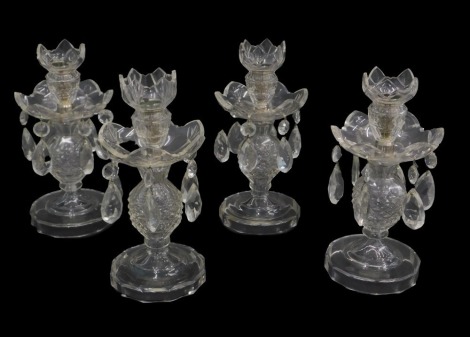 A set of four cut glass candlesticks, each with lustre drops, on a circular base, 26cm high.