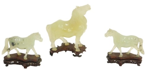 A Chinese jade coloured horse, and a pair of smaller examples, 14cm and 12cm high respectively. (AF)