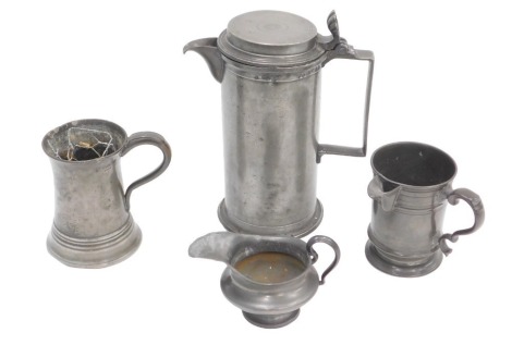 A French cylindrical pewter flagon, the hinged lid initialled HJ, various marks to side, 25cm high, two jugs, and a tankard. (4)