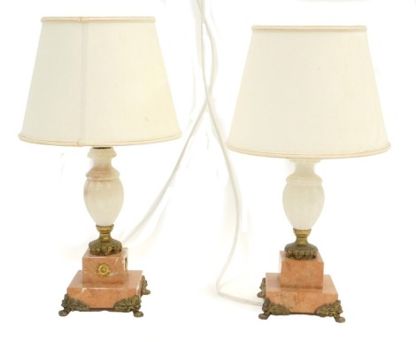 A pair of 20thC alabaster and marble table lamps, each with gilt metal mounts, 43cm high overall.