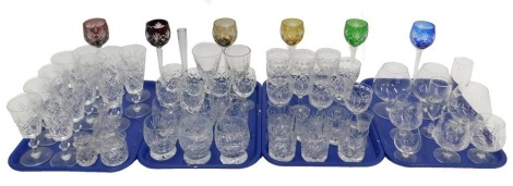 A large quantity of cut glass, various styles and designs, to include six coloured hock glasses. (4 trays)