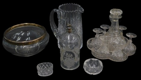 A cut glass liqueur set, comprising decanter and stopper, six glasses and stand, and other glass to include a bowl with silver mount.