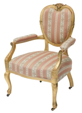 A late Victorian gilt open armchair, with heart shaped show frame back, striped upholstery and later gilding.