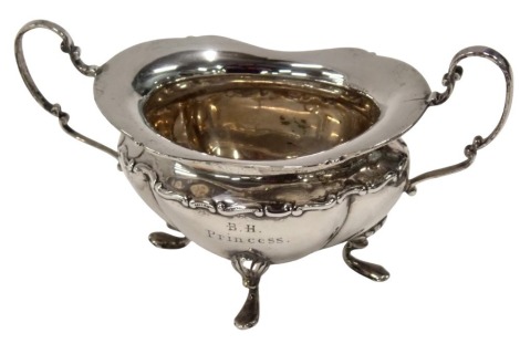 A Victorian silver two handled sugar bowl, with a fluted border, on shell capped claw feet, inscribed BH Princess, Mappin and Webb Sheffield 1899, 3.45oz.