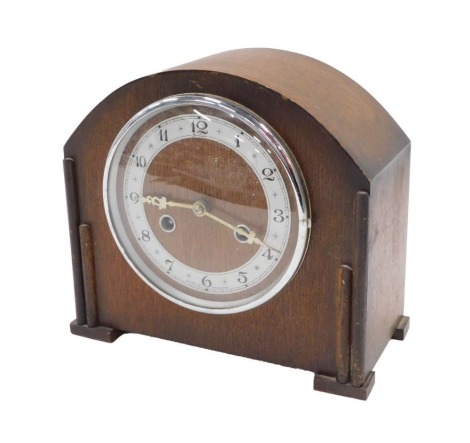 A Bentima 1950s oak cased mantel clock, with a silvered numeric dial and gold hands, 22cm high, 22cm wide, 11cm deep.