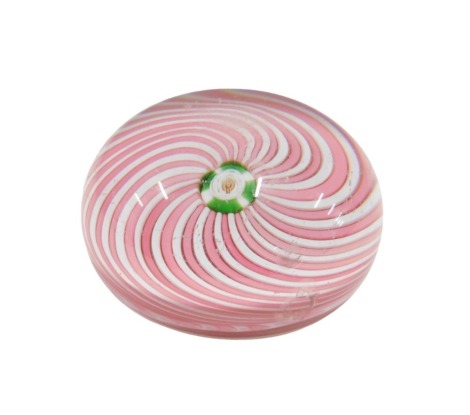 A Murano Zanfirico style paperweight, with twisted decoration in pink and white surrounding a central roundel, with single cane, 8cm diameter.