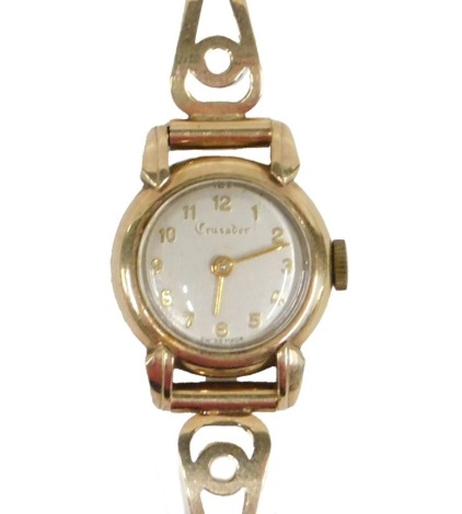 A mid 20thC Crusader lady's 9ct gold wristwatch, with a silvered dial, and three bar bracelet, London 1952, 15.30g all in.