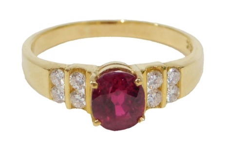 A 20thC ruby and diamond multi stone dress ring, set with oval cut ruby, 6.5mm x 5.5mm x 4.72mm, approx 1.52ct, flanked by four section two round brilliant cut diamonds, eight in total, each approx 2mm x 2mm x 1.2mm, 0.03ct, yellow metal with rubbed marki