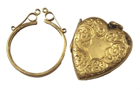 A 9ct gold coin pendant mount, 1.1g, and a plated heart shaped locket. (2)