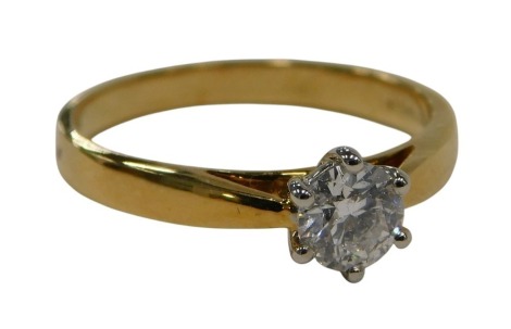 An 18ct gold diamond solitaire ring, set with round brilliant cut diamond approx 0.4cts, claw set, white gold setting on yellow gold band, 3.2g all in.