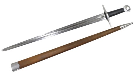 An ancient warrior replica sword, with wooden sheath, and moulded black leatherette handle, 103cm long.