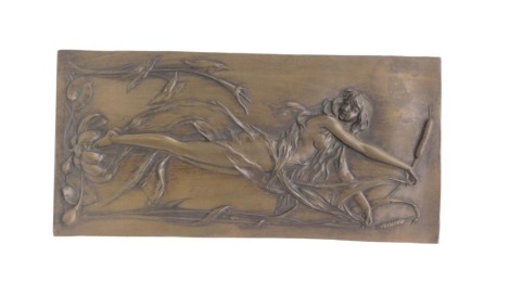 A bronzed resin plaque, decorated in Art Nouveau style with a female figure beside bull rushes, lilies, etc., 30cm high, 15cm wide.